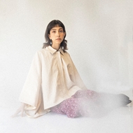 ITIZ Butterfly poncho in cream color worn by model, showcasing loose fit and free movement