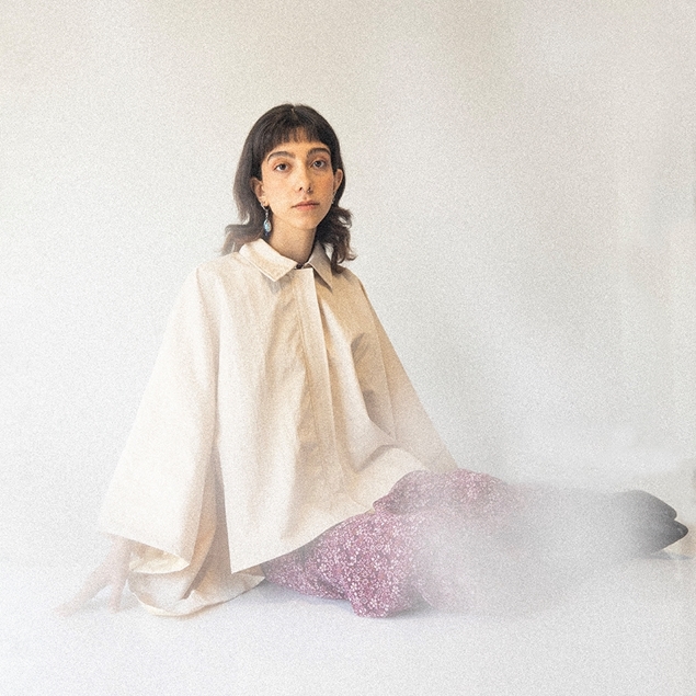 ITIZ Butterfly poncho in cream color worn by model, showcasing loose fit and free movement
